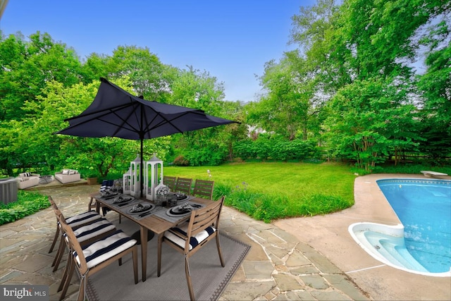view of patio with outdoor dining space, an outdoor pool, and view of scattered trees