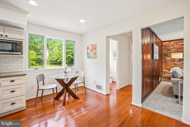 dining space with light wood-type flooring, baseboards, and recessed lighting