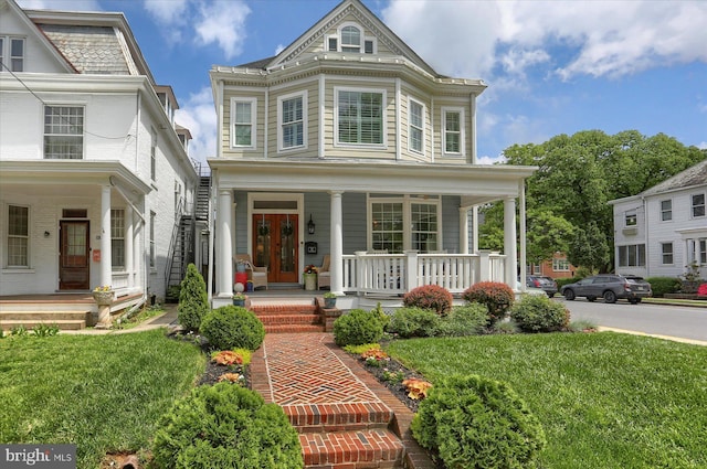 65 S College St, Carlisle, PA 17013 - view of front of property featuring a porch and a front lawn