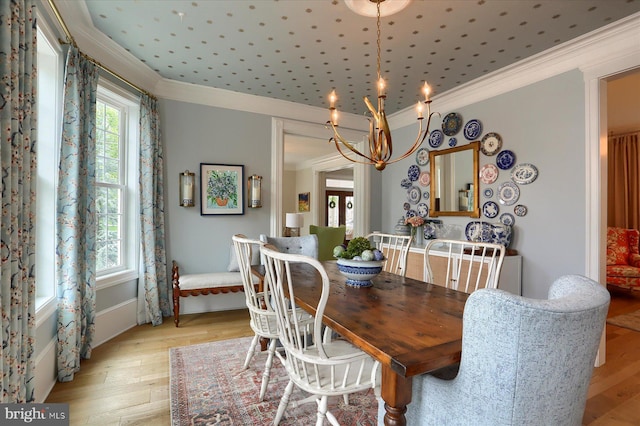 65 S College St, Carlisle, PA 17013 - dining area with crown molding, a chandelier, and light wood-style flooring