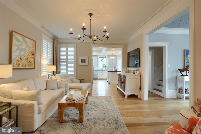 65 S College St, Carlisle, PA 17013 - living area with a chandelier, crown molding, light wood-style floors, and stairs