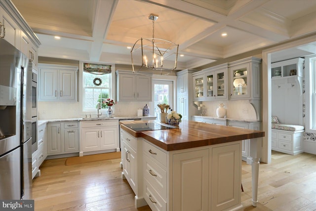 65 S College St, Carlisle, PA 17013 - kitchen with wood counters, coffered ceiling, light wood finished floors, tasteful backsplash, and beamed ceiling