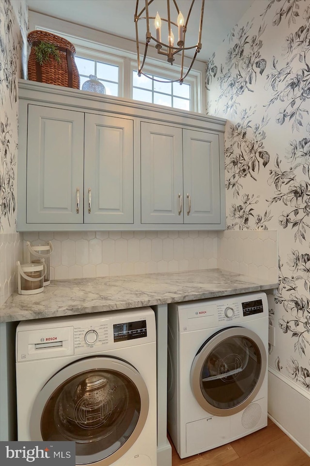 65 S College St, Carlisle, PA 17013 - laundry room with wallpapered walls, cabinet space, washing machine and clothes dryer, healthy amount of natural light, and a chandelier