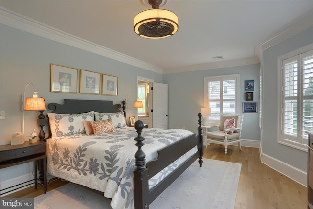 65 S College St, Carlisle, PA 17013 - bedroom with ornamental molding, multiple windows, wood finished floors, and baseboards