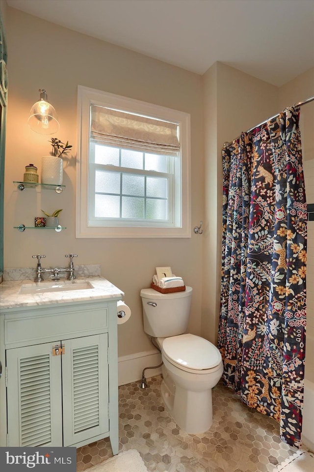 65 S College St, Carlisle, PA 17013 - full bath featuring toilet, vanity, a shower with curtain, baseboards, and tile patterned flooring