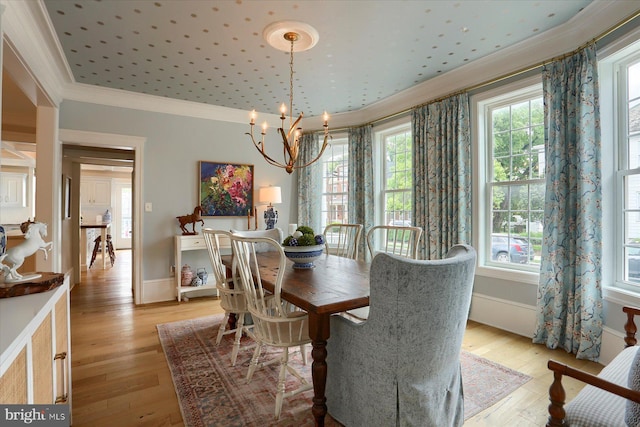 65 S College St, Carlisle, PA 17013 - dining area with ornamental molding, a chandelier, plenty of natural light, and light wood-type flooring