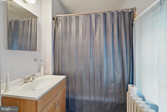 full bathroom with vanity and radiator