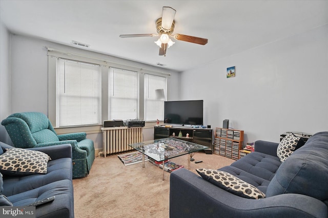 carpeted living room with ceiling fan