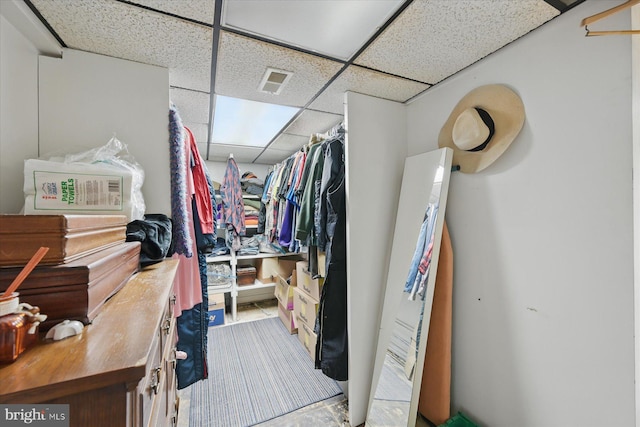 walk in closet with a paneled ceiling