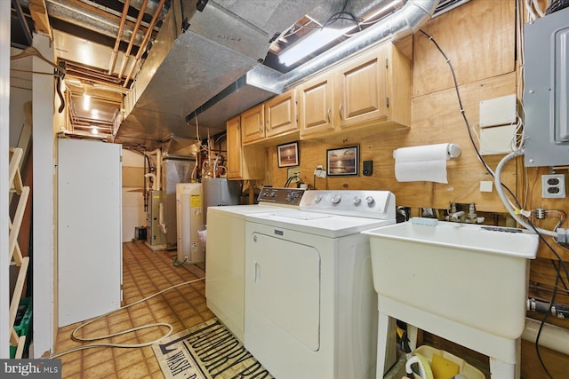washroom featuring light flooring, washer and dryer, cabinet space, water heater, and electric panel