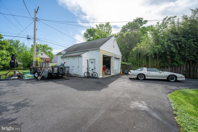 detached garage featuring fence
