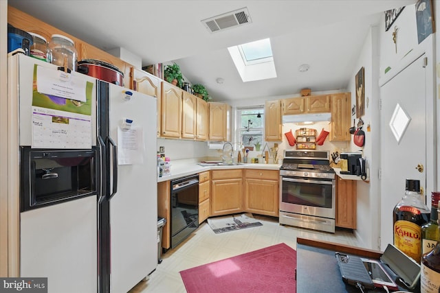 kitchen featuring stainless steel range with gas stovetop, white fridge with ice dispenser, black dishwasher, a skylight, and under cabinet range hood