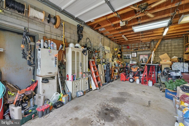 garage with a workshop area and a garage door opener