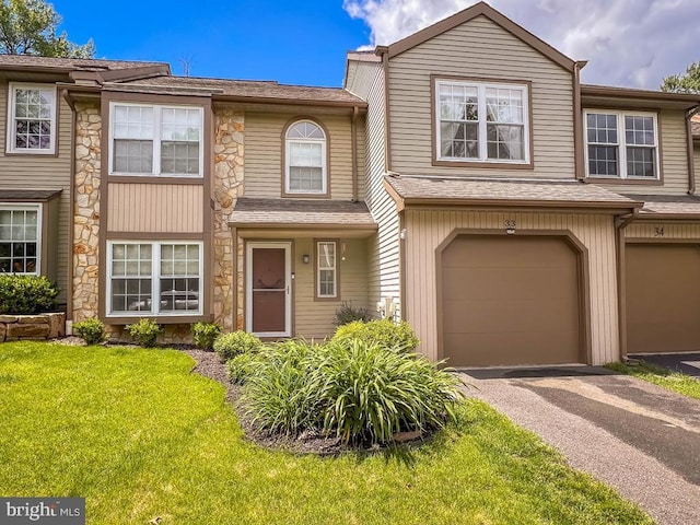 33 Laurel Cir, Newtown, PA 18940 - townhome / multi-family property with driveway, an attached garage, stone siding, and a front yard