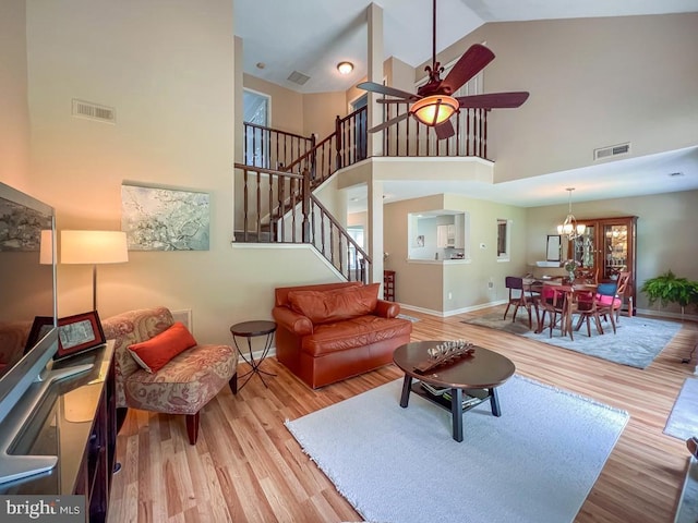 33 Laurel Cir, Newtown, PA 18940 - living room featuring high vaulted ceiling, wood finished floors, ceiling fan, stairs, and baseboards
