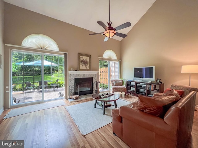 33 Laurel Cir, Newtown, PA 18940 - living room featuring high vaulted ceiling, a ceiling fan, wood finished floors, and a glass covered fireplace