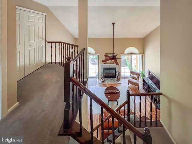 33 Laurel Cir, Newtown, PA 18940 - stairs featuring carpet flooring, a fireplace, a ceiling fan, vaulted ceiling, and baseboards