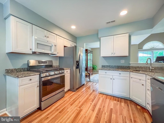 33 Laurel Cir, Newtown, PA 18940 - kitchen featuring appliances with stainless steel finishes, white cabinets, a sink, light wood-style floors, and recessed lighting