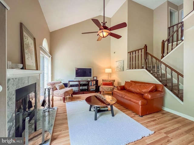 33 Laurel Cir, Newtown, PA 18940 - living area with wood finished floors, a ceiling fan, high vaulted ceiling, stairway, and a high end fireplace