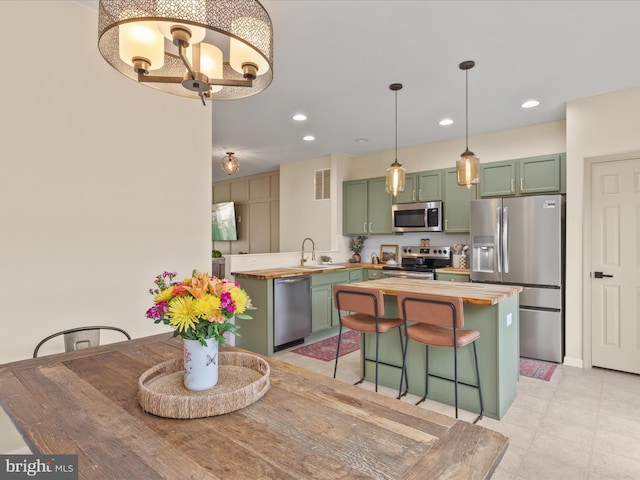 38 Freeborn Ln, Camden Wyoming, DE 19934 - kitchen featuring stainless steel appliances, green cabinetry, butcher block countertops, a chandelier, and recessed lighting