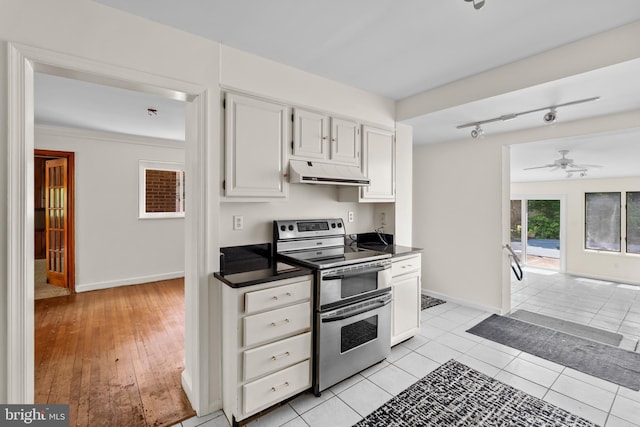 10699 Harding Rd, Laurel, MD 20723 - kitchen featuring range with two ovens, under cabinet range hood, a ceiling fan, dark countertops, and baseboards
