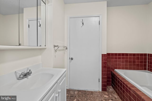 10699 Harding Rd, Laurel, MD 20723 - full bathroom featuring a garden tub, vanity, tile walls, and wainscoting