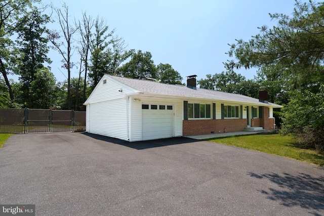 10699 Harding Rd, Laurel, MD 20723 - view of front of property featuring a chimney, driveway, brick siding, and a gate