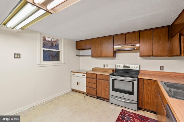 10699 Harding Rd, Laurel, MD 20723 - kitchen featuring appliances with stainless steel finishes, under cabinet range hood, brown cabinetry, and light flooring