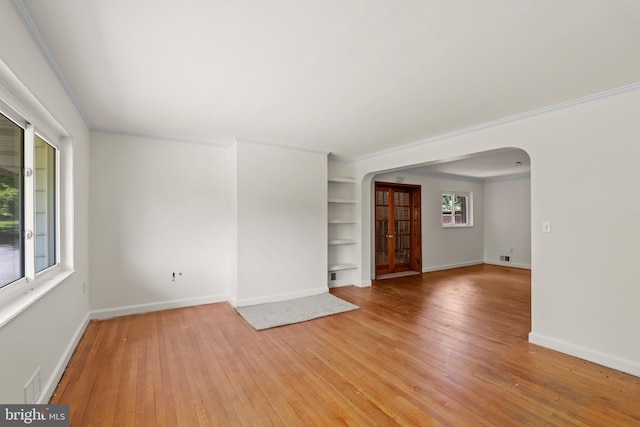 10699 Harding Rd, Laurel, MD 20723 - unfurnished room with arched walkways, built in features, light wood-style floors, baseboards, and ornamental molding