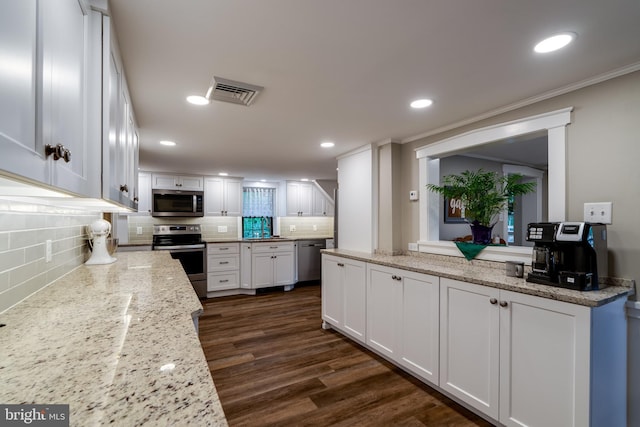 1626 Lampeter Rd, Lancaster, PA 17602 - kitchen featuring stainless steel appliances, white cabinetry, tasteful backsplash, dark wood-style floors, and recessed lighting