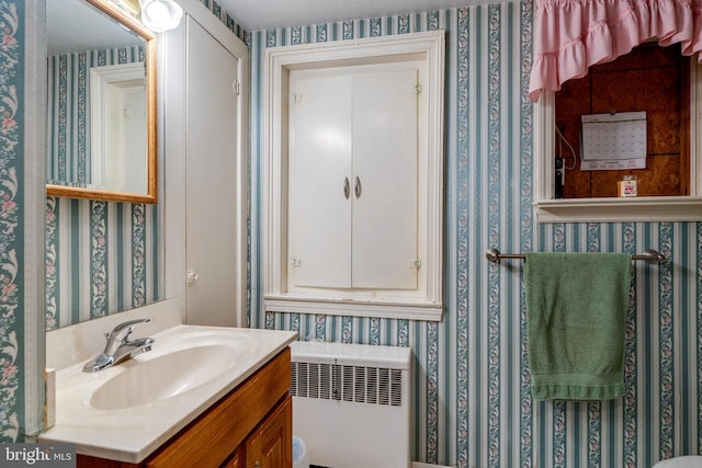 1626 Lampeter Rd, Lancaster, PA 17602 - bathroom with radiator, wallpapered walls, and vanity