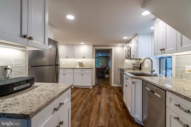 1626 Lampeter Rd, Lancaster, PA 17602 - kitchen with appliances with stainless steel finishes, a sink, tasteful backsplash, dark wood-type flooring, and white cabinetry