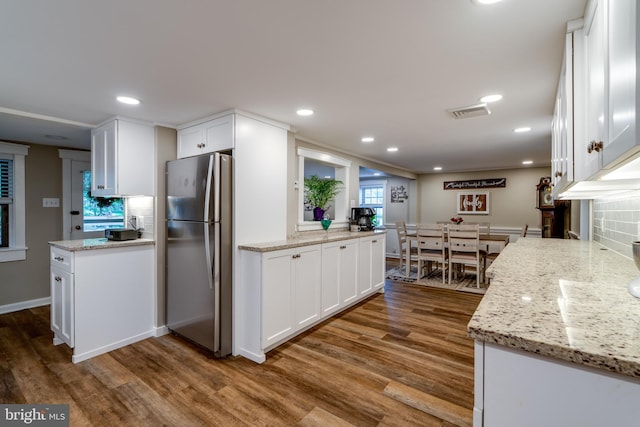 1626 Lampeter Rd, Lancaster, PA 17602 - kitchen featuring freestanding refrigerator, dark wood finished floors, white cabinetry, light stone counters, and recessed lighting
