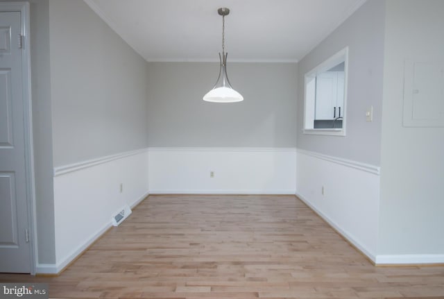 243 Loudoun St SW Unit F, Leesburg, VA 20175 - spare room featuring light wood-style flooring, ornamental molding, and baseboards