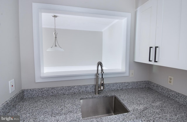 243 Loudoun St SW Unit F, Leesburg, VA 20175 - kitchen view of a sink, white cabinets, light stone counters, and hanging light fixtures