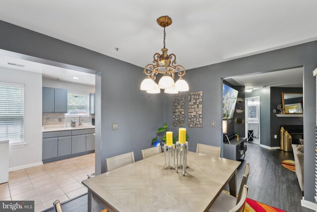 15609 Everglade Ln Unit F002, Bowie, MD 20716 - dining space with a chandelier, baseboards, and light wood-style floors