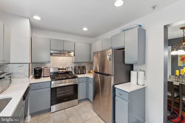 15609 Everglade Ln Unit F002, Bowie, MD 20716 - kitchen with stainless steel appliances, under cabinet range hood, gray cabinetry, backsplash, and recessed lighting