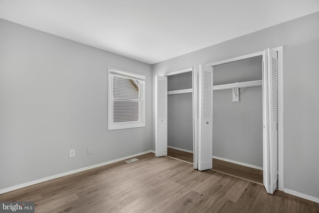 20 Executive Ln, Willingboro, NJ 08046 - unfurnished bedroom with two closets, wood finished floors, and baseboards
