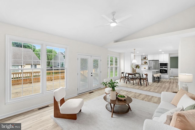 2619 Stone Mountain Ct, Herndon, VA 20170 - living room with light wood-style floors, french doors, plenty of natural light, and lofted ceiling