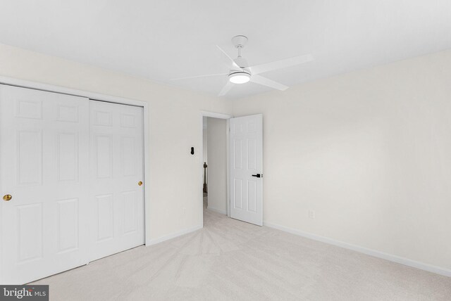2619 Stone Mountain Ct, Herndon, VA 20170 - unfurnished bedroom featuring light colored carpet, a closet, baseboards, and a ceiling fan