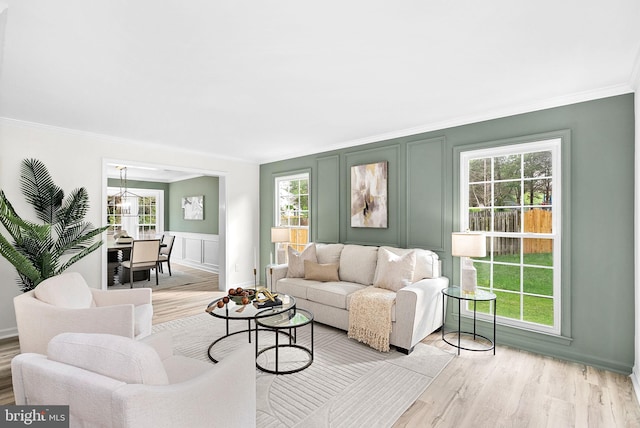 2619 Stone Mountain Ct, Herndon, VA 20170 - living room featuring a decorative wall, ornamental molding, light wood-style floors, and healthy amount of natural light