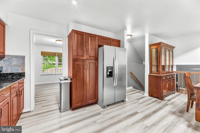 8328 Ridge View Rd, Lusby, MD 20657 - kitchen featuring stainless steel fridge, light wood-style floors, stone counters, baseboards, and glass insert cabinets