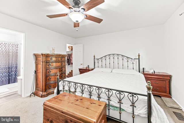 8328 Ridge View Rd, Lusby, MD 20657 - carpeted bedroom with a spacious closet, a closet, ensuite bathroom, baseboards, and a ceiling fan