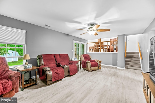 8328 Ridge View Rd, Lusby, MD 20657 - living room with ceiling fan, stairs, plenty of natural light, and wood finished floors