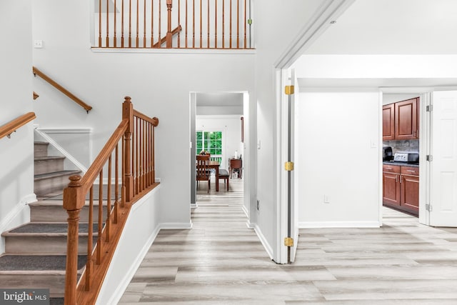 8328 Ridge View Rd, Lusby, MD 20657 - foyer entrance with light wood-type flooring, stairway, and baseboards