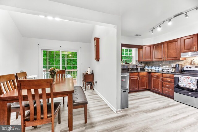 8328 Ridge View Rd, Lusby, MD 20657 - kitchen featuring electric range, under cabinet range hood, light wood-style flooring, a sink, and decorative backsplash