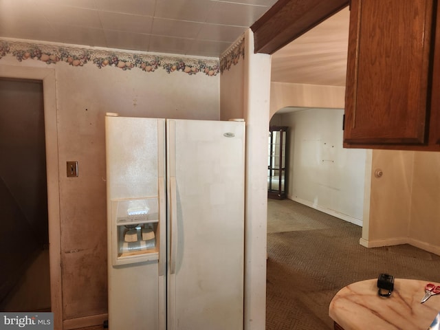 841 Highland Ave, Lancaster, PA 17603 - kitchen featuring white refrigerator with ice dispenser, arched walkways, carpet floors, and baseboards