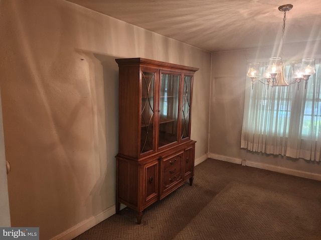 841 Highland Ave, Lancaster, PA 17603 - empty room featuring a chandelier, dark carpet, and baseboards