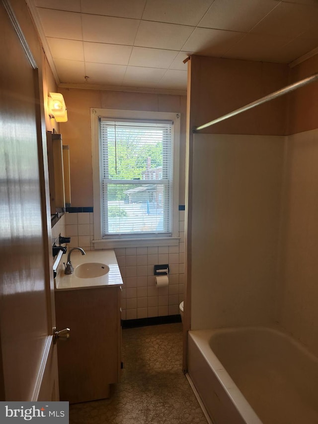 841 Highland Ave, Lancaster, PA 17603 - full bath with tile walls, vanity, toilet, wainscoting, and shower / bathtub combination