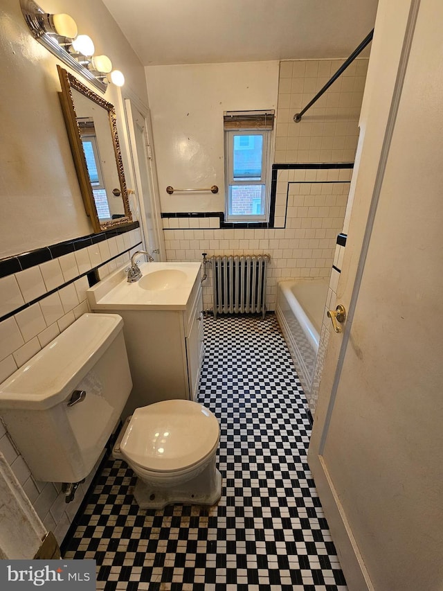 3 W Elm Ave, Baltimore, MD 21206 - full bath featuring radiator, tile walls, toilet, tile patterned floors, and vanity